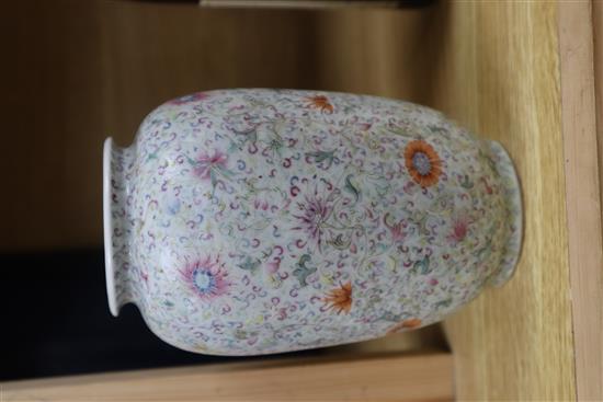 A Chinese famille rose ovoid vase, Qing dynasty, finely painted with flowers and scrolling foliage, H. 15cm, drilled hole to side of ba